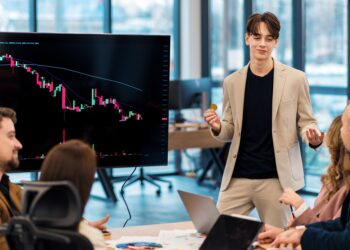 young-worker-leading-business-meeting-about-cryptocurrencies-office